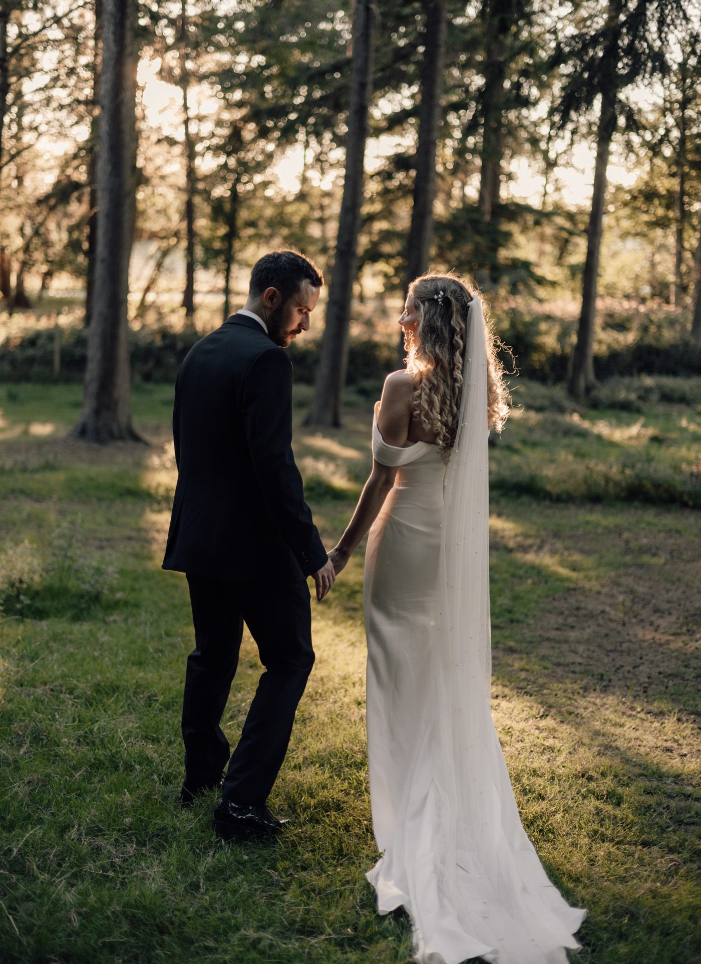 Ruby and Luke holding hands in the evening sun, Harewood